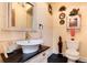 Elegant bathroom with vessel sink, granite counter, decorative mirror, and toilet at 7794 Louviers Blvd, Louviers, CO 80131