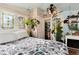 Bright bedroom featuring stained-glass windows, light-colored wood paneling, and eclectic decor, offering a cozy retreat at 7794 Louviers Blvd, Louviers, CO 80131