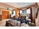 Comfortable bedroom featuring carpeted floors, a ceiling fan, and natural light at 7794 Louviers Blvd, Louviers, CO 80131