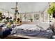 Unique bedroom with large windows, charming decor, and plant accents, creating a serene and inviting atmosphere at 7794 Louviers Blvd, Louviers, CO 80131