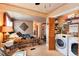 Bedroom with carpeted floors, decorative wall art, a closet, and a laundry area at 7794 Louviers Blvd, Louviers, CO 80131