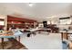 Spacious and well-lit bonus room with tables, shelving, and storage areas at 7794 Louviers Blvd, Louviers, CO 80131