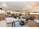 Bright bonus room featuring multiple tables and workspaces under bright windows at 7794 Louviers Blvd, Louviers, CO 80131