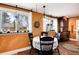 Cozy dining area with decorative chandelier lighting and natural light from windows overlooking the front yard at 7794 Louviers Blvd, Louviers, CO 80131