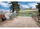 Large property with an outbuilding, a greenhouse, ample parking, and well-maintained landscaping, offering versatile space at 7794 Louviers Blvd, Louviers, CO 80131