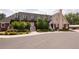 Multi-story building with charming architectural details, lush landscaping, and ample parking at 7794 Louviers Blvd, Louviers, CO 80131