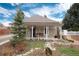Charming bungalow with inviting front porch and whimsical landscaping at 7794 Louviers Blvd, Louviers, CO 80131