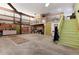 Large garage with a loft space accessible by stairs, lots of storage, and concrete flooring at 7794 Louviers Blvd, Louviers, CO 80131