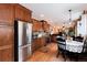 Spacious kitchen featuring stainless steel appliances, dark wood cabinets, and granite countertops at 7794 Louviers Blvd, Louviers, CO 80131