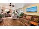 Inviting living room featuring a ceiling fan, comfortable seating, and natural light, creating a cozy atmosphere at 7794 Louviers Blvd, Louviers, CO 80131