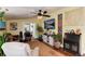 Bright living room with stylish decor, a ceiling fan, and a decorative cabinet, perfect for relaxation and entertaining at 7794 Louviers Blvd, Louviers, CO 80131