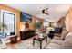 Open concept living room with modern furnishings, large window, and view into kitchen at 7794 Louviers Blvd, Louviers, CO 80131