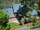 Aerial shot showcasing a well-maintained property with a distinctive roof and lush greenery in a serene setting at 2504 S Garfield St, Denver, CO 80210