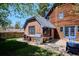 Backyard featuring a patio, outdoor grill, grassy area, and brick exterior at 2504 S Garfield St, Denver, CO 80210