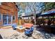 Backyard with wood fence, a stone fire pit, dining table with umbrella and lawn at 2504 S Garfield St, Denver, CO 80210