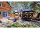 Backyard with wood fence, a stone fire pit, dining table with umbrella and lawn at 2504 S Garfield St, Denver, CO 80210