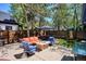 Backyard with wood fence, a stone fire pit, dining table with umbrella and lawn at 2504 S Garfield St, Denver, CO 80210