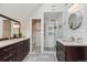 Bright bathroom featuring double sink vanity, tiled floors and a glass enclosed shower with rainfall showerhead at 2504 S Garfield St, Denver, CO 80210