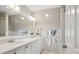 Bright bathroom with white cabinets, quartz countertop, large mirror, and decorative accents at 2504 S Garfield St, Denver, CO 80210