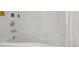 Close-up of white bathtub with subway tile surround and chrome fixtures at 2504 S Garfield St, Denver, CO 80210