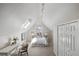 Bedroom with skylight, white bedding, desk area, and neutral color scheme at 2504 S Garfield St, Denver, CO 80210