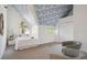 Bedroom with vaulted ceiling, triangular window, white bedding, and cozy seating area at 2504 S Garfield St, Denver, CO 80210