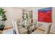 Dining room featuring a glass table, seating for six, and bright artwork at 2504 S Garfield St, Denver, CO 80210