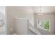 Hallway with stairway, neutral walls, white trim, and window providing natural light at 2504 S Garfield St, Denver, CO 80210