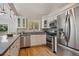Well-equipped kitchen featuring white cabinets, stainless steel appliances, and hardwood flooring at 2504 S Garfield St, Denver, CO 80210