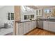Bright kitchen with white cabinets, granite countertops, and a large window overlooking the backyard at 2504 S Garfield St, Denver, CO 80210