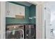 Modern laundry room featuring front-load washer and dryer and ample cabinet space at 2504 S Garfield St, Denver, CO 80210