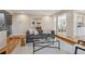 Cozy living room with plush seating, a glass coffee table, and seamless transition to the dining room at 2504 S Garfield St, Denver, CO 80210