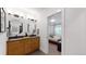 Shared bathroom with double vanity and access to bedroom at 2980 E 102Nd Pl, Thornton, CO 80229