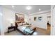 Spacious bedroom with mid-century modern furniture and large art piece at 2980 E 102Nd Pl, Thornton, CO 80229