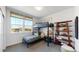 Bright bedroom with built-in bunk bed, shelving, and large windows at 2980 E 102Nd Pl, Thornton, CO 80229