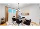 Elegant dining room with a glass table, dark chairs, and modern chandelier at 2980 E 102Nd Pl, Thornton, CO 80229