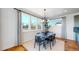 Bright dining room with large windows, hardwood floors, and modern light fixture at 2980 E 102Nd Pl, Thornton, CO 80229