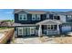 Two-story home with gray siding, stone accents, and a front porch at 2980 E 102Nd Pl, Thornton, CO 80229