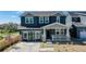 Two-story home with gray siding, stone accents, and a front porch at 2980 E 102Nd Pl, Thornton, CO 80229