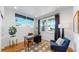 Bright home office with hardwood floors, built-in shelving, and ample natural light at 2980 E 102Nd Pl, Thornton, CO 80229