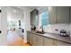 Modern kitchen with gray cabinets, quartz countertops, and stainless steel appliances at 2980 E 102Nd Pl, Thornton, CO 80229