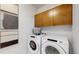 Convenient laundry room with washer, dryer, and cabinets at 2980 E 102Nd Pl, Thornton, CO 80229