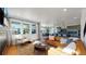 Open living space with hardwood floors, fireplace, and view of kitchen at 2980 E 102Nd Pl, Thornton, CO 80229