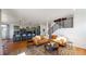 Open concept living room with kitchen view, hardwood floors, and stylish furniture at 2980 E 102Nd Pl, Thornton, CO 80229