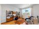 Cozy loft area with a comfortable chair, built-in shelving, and hardwood floors at 2980 E 102Nd Pl, Thornton, CO 80229
