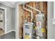 Basement mechanical room with a water heater and furnace at 6842 Garland St, Arvada, CO 80004