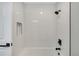 Modern white-tiled shower featuring dark bronze shower head and fixture at 6842 Garland St, Arvada, CO 80004