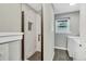 Bright bathroom featuring a tiled shower with glass door and an adjacent laundry area at 6842 Garland St, Arvada, CO 80004