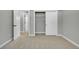 Bedroom showcasing neutral walls and carpet, closet, and a hallway entryway at 6842 Garland St, Arvada, CO 80004