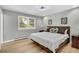 Comfortable bedroom with a comfortable bed, wood floors, and a large window with backyard views at 6842 Garland St, Arvada, CO 80004